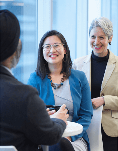 3 OHA staff members laughing together. 