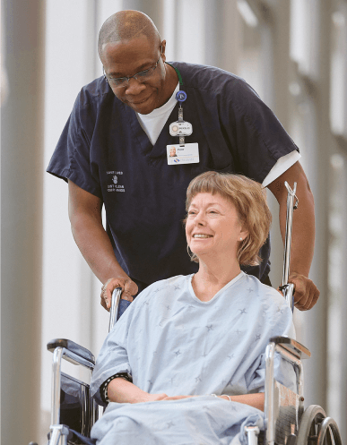 Southlake Regional Health Centre staff transports patient in a wheelchair.